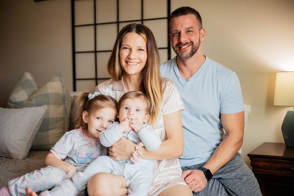 Family cuddling together on the couch during an in-home family photography session in Dahlonega, GA.