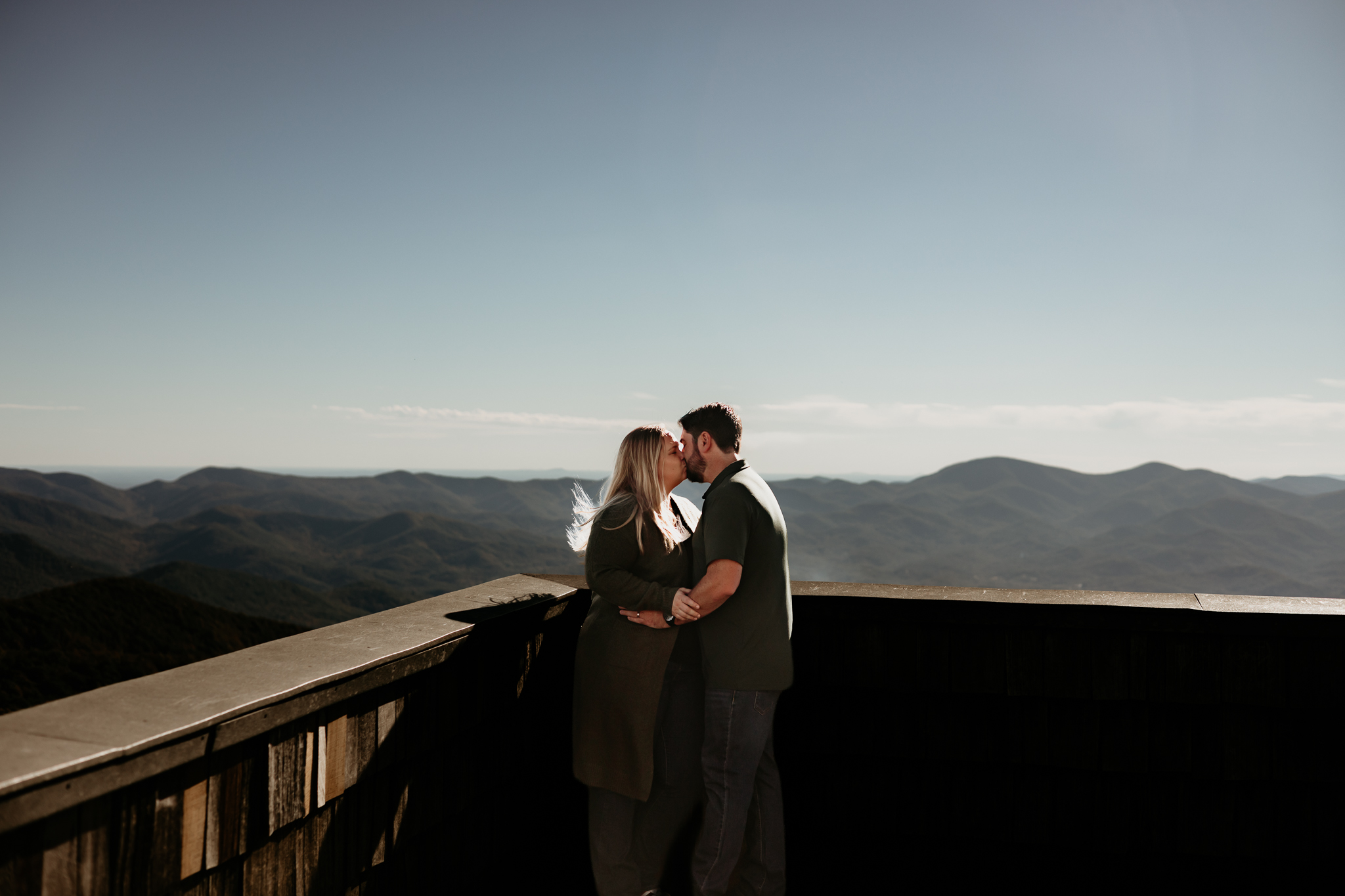 North Georgia mountain couple photography featuring a couple kissing at a scenic mountain overlook during their fall vacation.